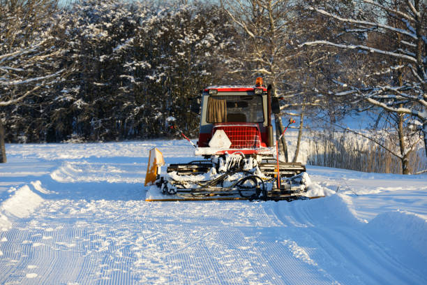 ski plow in the winter in the forest on a sunny day