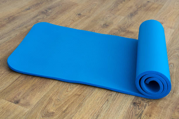 istock Training and yoga mat on wooden background 1126970090
