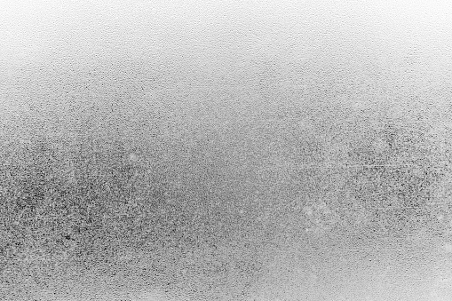 The texture of misted glass. Drops on the glass. Black and white picture