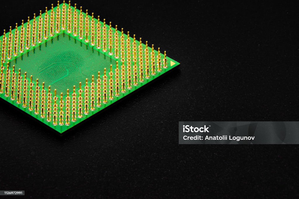 Contacts of the processor for the personal computer The processor for a personal computer has many pins for connecting to devices on the motherboard. Gold plated contacts Connection Block Stock Photo