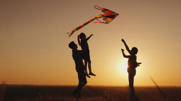 istock Summer activity - the family plays carefree with a kite 1126974497