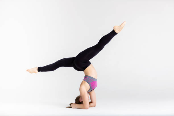 istock Young sportwoman stretching muscles on white background 1126974709