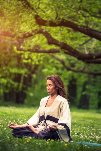 istock attractive woman practicing yoga in nature 1126975672