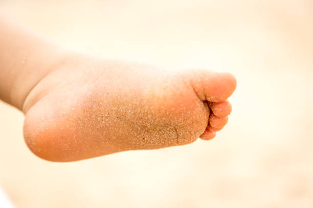 istock Baby's feet on the beach in Portugal 1126975704