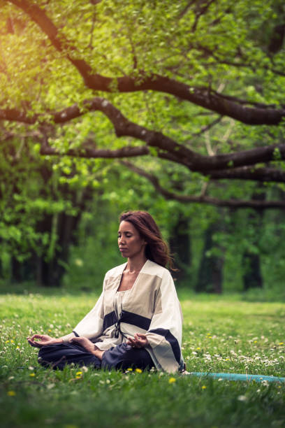 istock attractive woman practicing yoga in nature 1126975822