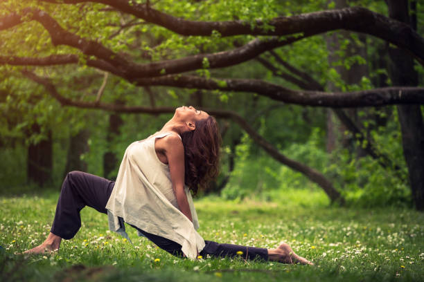 istock attractive woman practicing yoga in nature 1126978429