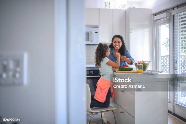 Mother And Daughter Cooking Food In Kitchen Stock Photo - Download Image Now - Family, Kitchen, Mother