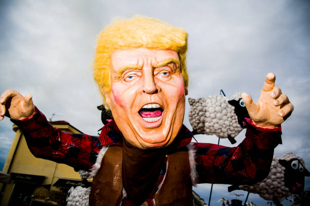 Viareggio's carnival VIAREGGIO.ITALY-FEBRAUARY 4: Donald Trump parody on allegorical wagon during Viareggio Carnival, Italy on the 4th february 2018 in Italy. painted masquerade masks stock pictures, royalty-free photos & images
