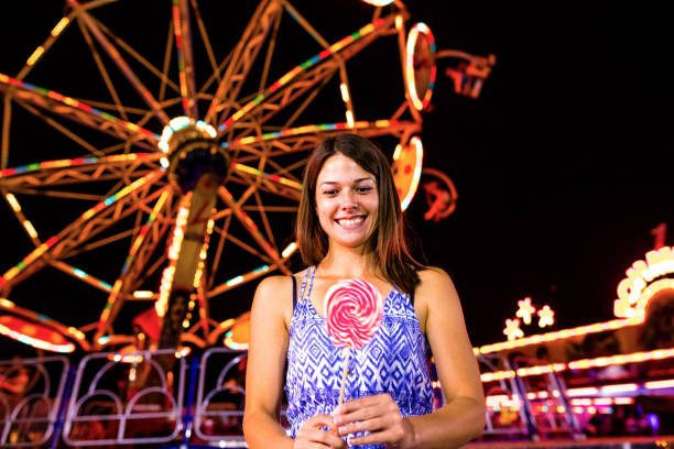 istock Fun with lollipop at a fun fair 1126999998
