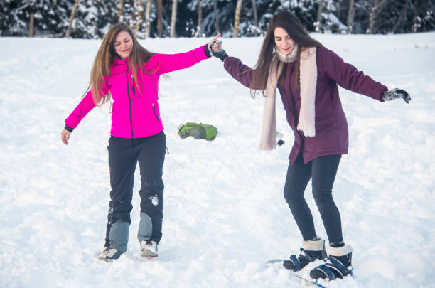 istock Snowboard instructor with a young beautiful female student. 1127010647