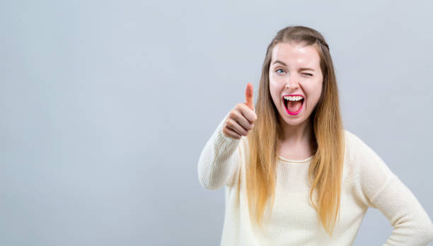 istock Young woman giving thumb up 1127011359
