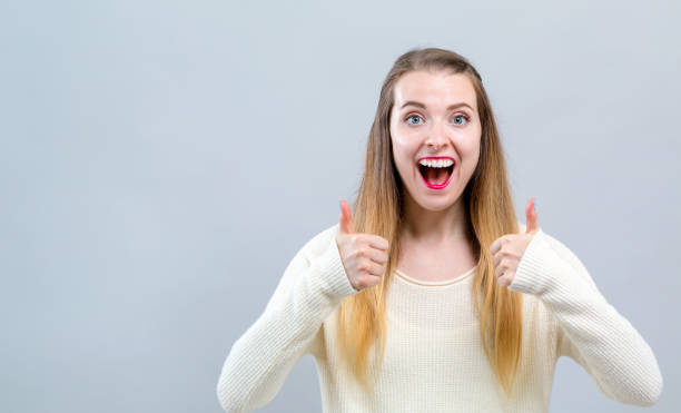 istock Young woman giving thumbs up 1127011373