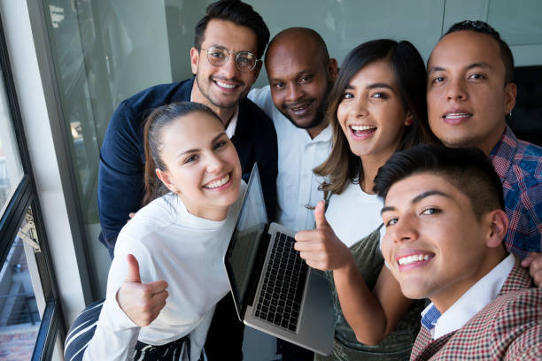 Selfie among friends at work A working group of latin of different races and ages feels motivated to start the workday latin script stock pictures, royalty-free photos & images