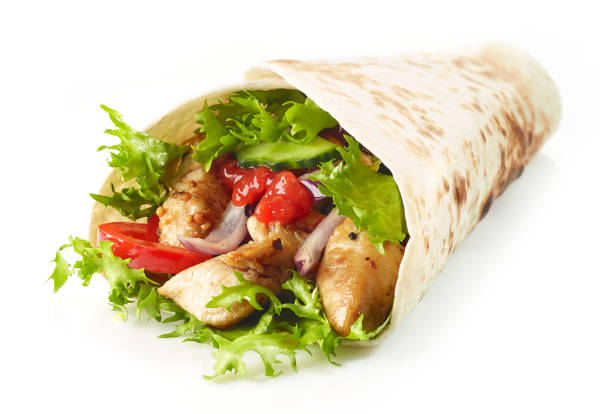 istock Tortilla wrap with fried chicken meat and vegetables 1127015537