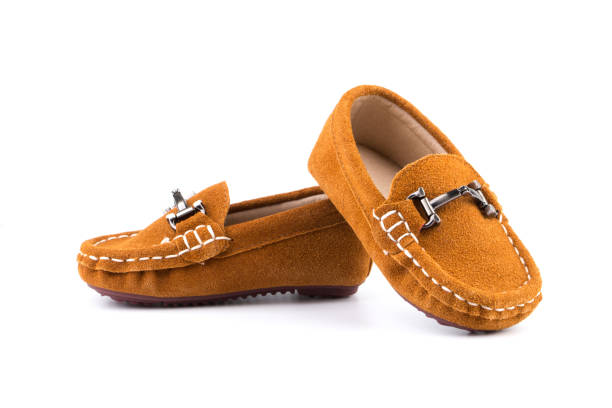 istock Small Child Shoes On White 1127024298