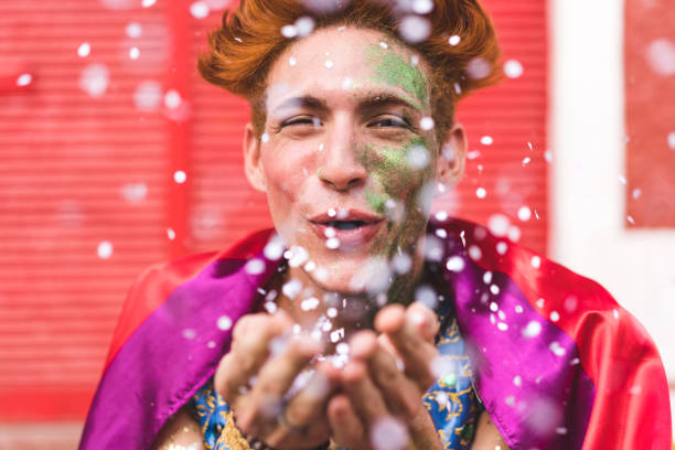 istock Homem blow confetti from hands 1127025738