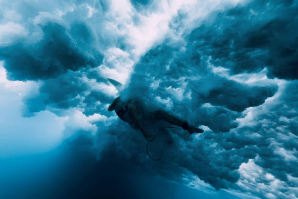 istock Surfer woman dive underwater. Wave washing surfer 1127028128