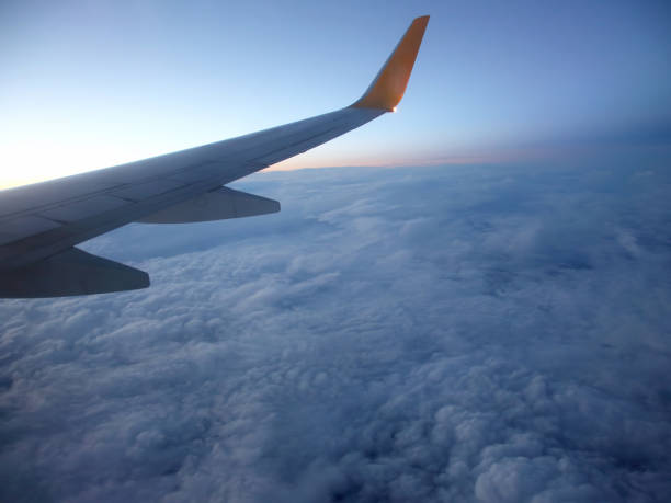 istock The wing of an airplane above the clouds 1127028985