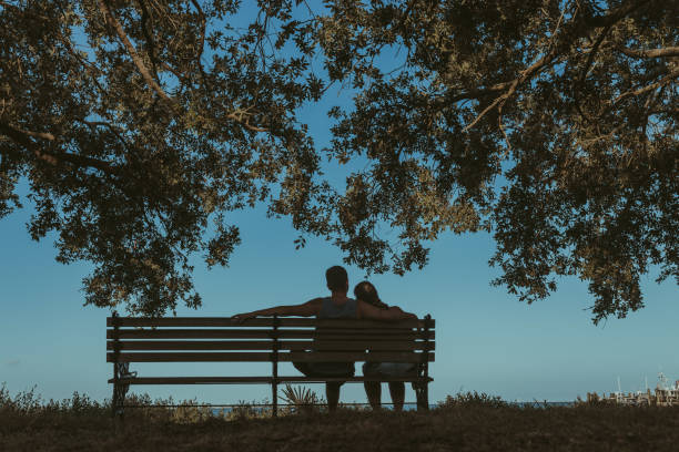 istock Couple sitting on the bench 1127031019