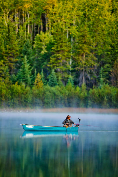 Jasper National Park in Alberta Canada Jasper National Park in Alberta Canada on September 23, 2012: Fishing on Patricia Lake, Jasper National Park rowing boat fishing stock pictures, royalty-free photos & images