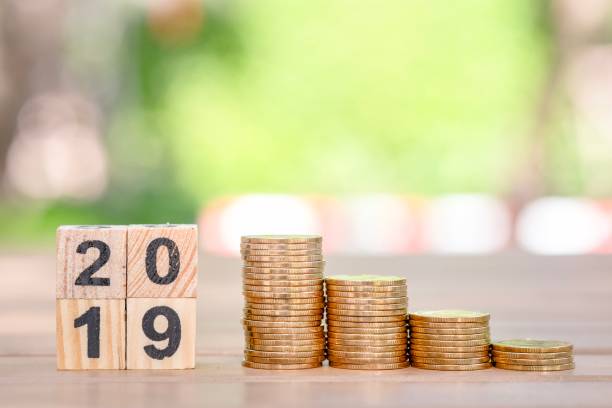 istock Growth of coins stack and wood blocks number 2019. 1127037325