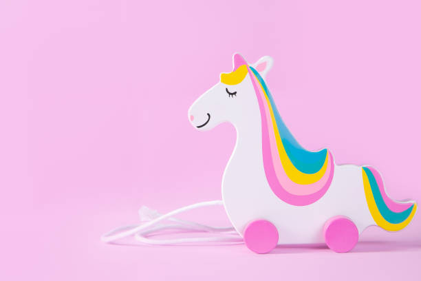 istock Minimalistic concept - toy unicorn on pink background 1127048543
