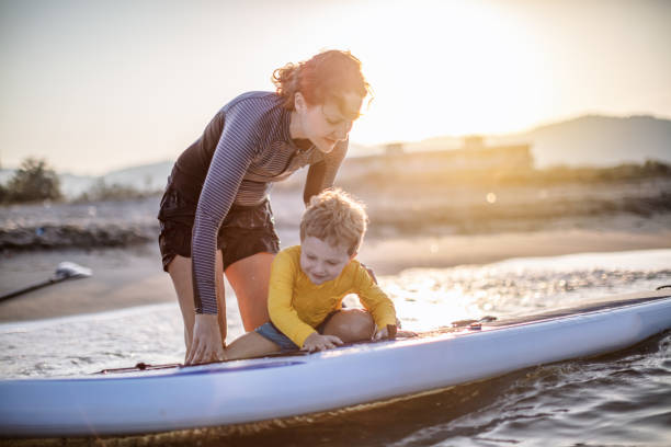 istock Mother and son having fun with paddle board 1127049804