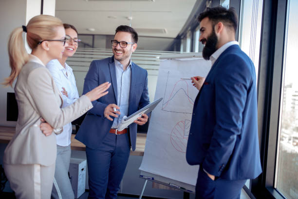istock Young attractive businessman showing presentation in board room 1127055176