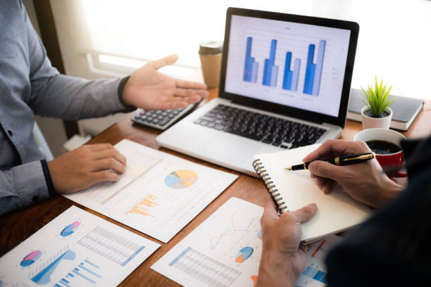business executives negotiate meeting in modern office discussing a quality data.