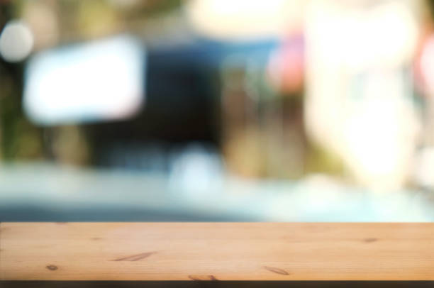 istock blank wood table with  blurred party outdoor background. 1127055486