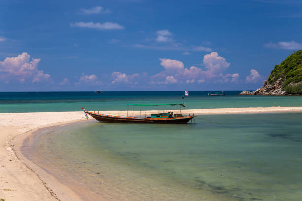 istock Traditional thai long boat moored at a beach 1127057014