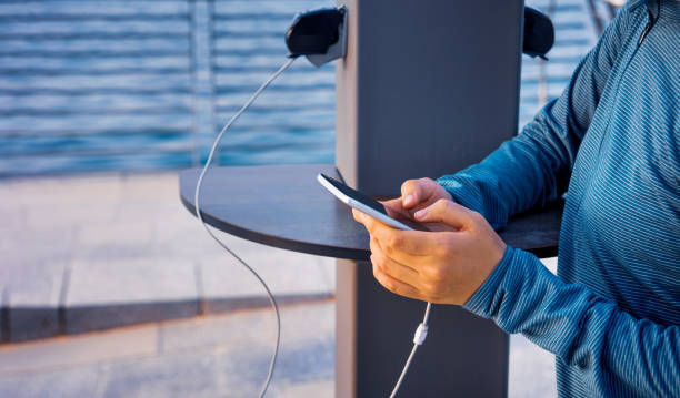 Female charging phone on a public charger