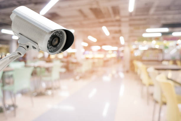 cctv security camera with abstract blurred food court background - department store shopping mall store inside of imagens e fotografias de stock