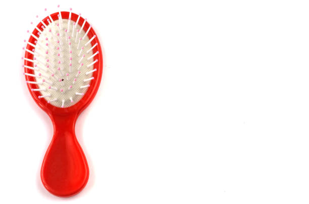 istock Elegant red hairbrush with handle isolated on white background. 1127057824