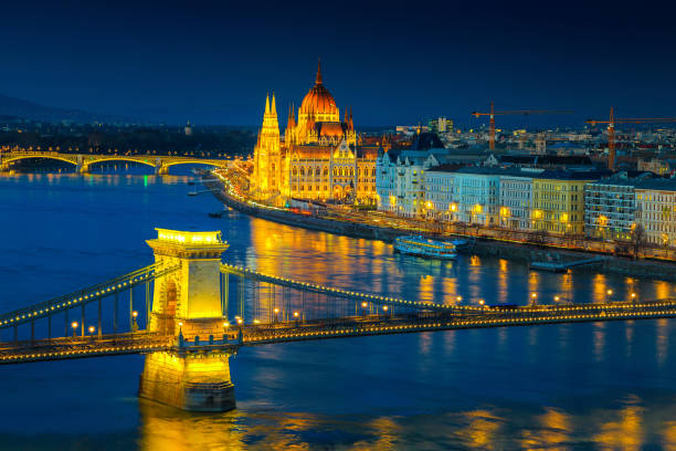 Iluminated Chain bridge and Parliament building at twilight, Budapest, Hungary Fantastic European touristic travel destination. Amazing cityscape panorama with famous iluminated Chain bridge and Hungarian Parliament building on Danube river at twilight, Budapest, Hungary, Europe budapest danube river cruise hungary stock pictures, royalty-free photos & images