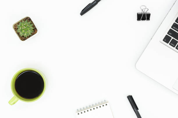 istock Modern white office desk with laptop, coffee and supplies. Top view with copy space, flat lay. 1127061991