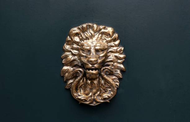 istock Old lion head door knob on dark gray  background 1127064854