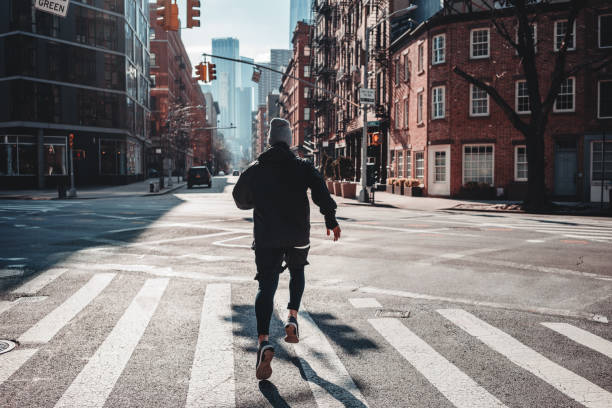istock Strong man runner training and running through urban streets. Athlete prepearing for marathone on New Your streets. Healthy run concept 1127065209