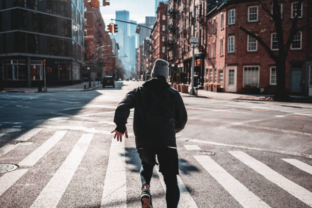 istock Man runner training and running on urban big street. Back view on male athlete while run through New-Yrok streets 1127065268