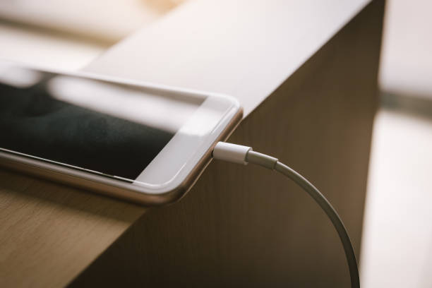 istock Smartphone charging with power bank on wood table. 1127065445