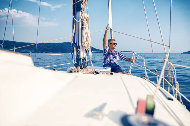 istock Man enjoying sailing with sailboat 1127065972