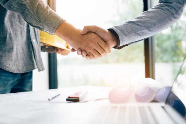 istock Two engineering man with construction worker greeting a foreman at renovating apartment. 1127066102