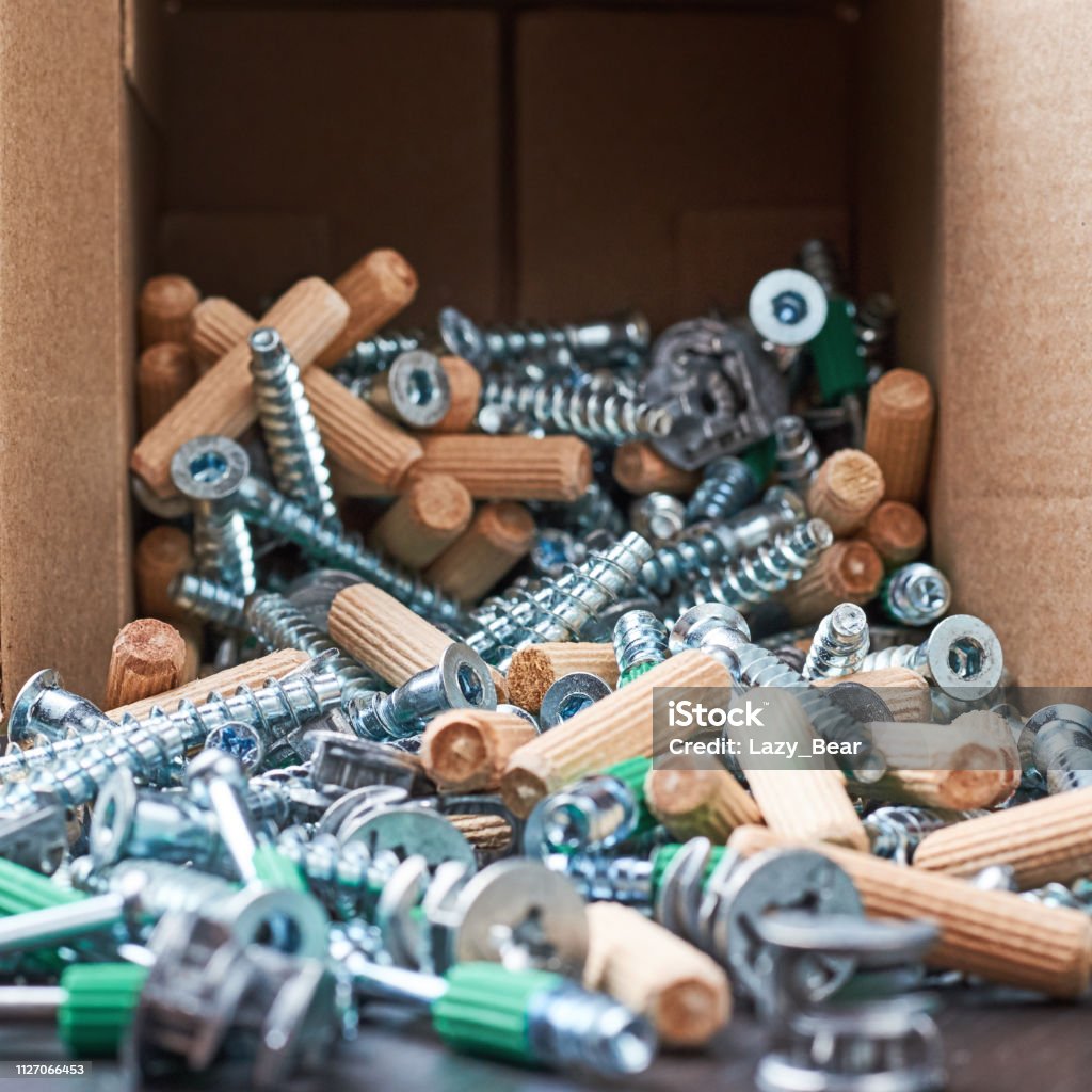 Open box with fall out tools for a furniture assembly, closeup Open box with fall out tools for furniture assembly, closeup Anchor - Vessel Part Stock Photo