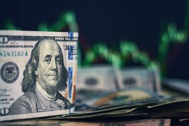 istock US dollar bills on a background with dynamics of exchange rates. Trading and financial risk concept 1127066487