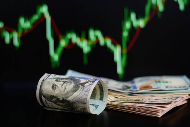 istock US dollar bills on a background with dynamics of exchange rates. Trading and financial risk concept 1127066493