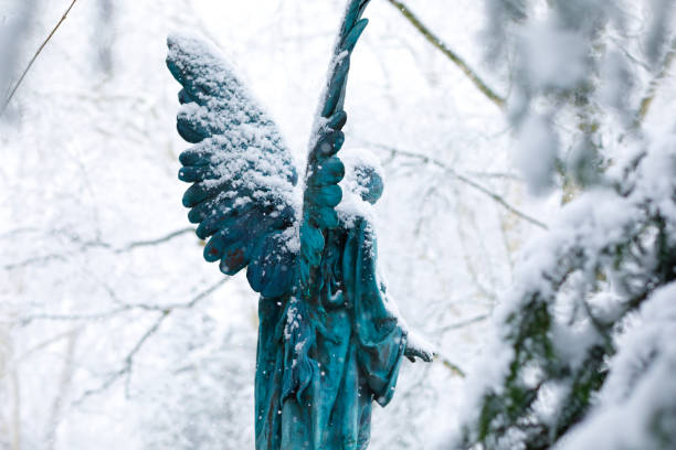 istock Antique Angel Statue on a Graveyard in deep Snow 1127069556