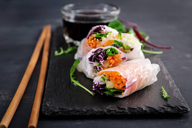 istock Vegetarian vietnamese spring rolls with spicy sauce, carrot, cucumber, red cabbage and rice noodle. Vegan food. Tasty meal.  Copy space 1127070859