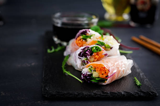 istock Vegetarian vietnamese spring rolls with spicy sauce, carrot, cucumber, red cabbage and rice noodle. Vegan food. Tasty meal.  Copy space 1127070862