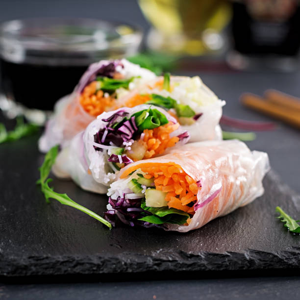 istock Vegetarian vietnamese spring rolls with spicy sauce, carrot, cucumber, red cabbage and rice noodle. Vegan food. Tasty meal.  Copy space 1127070864