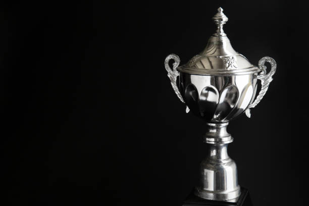 istock Close up of Silver trophy over black background. Winning awards with copy space for text and design 1127074882